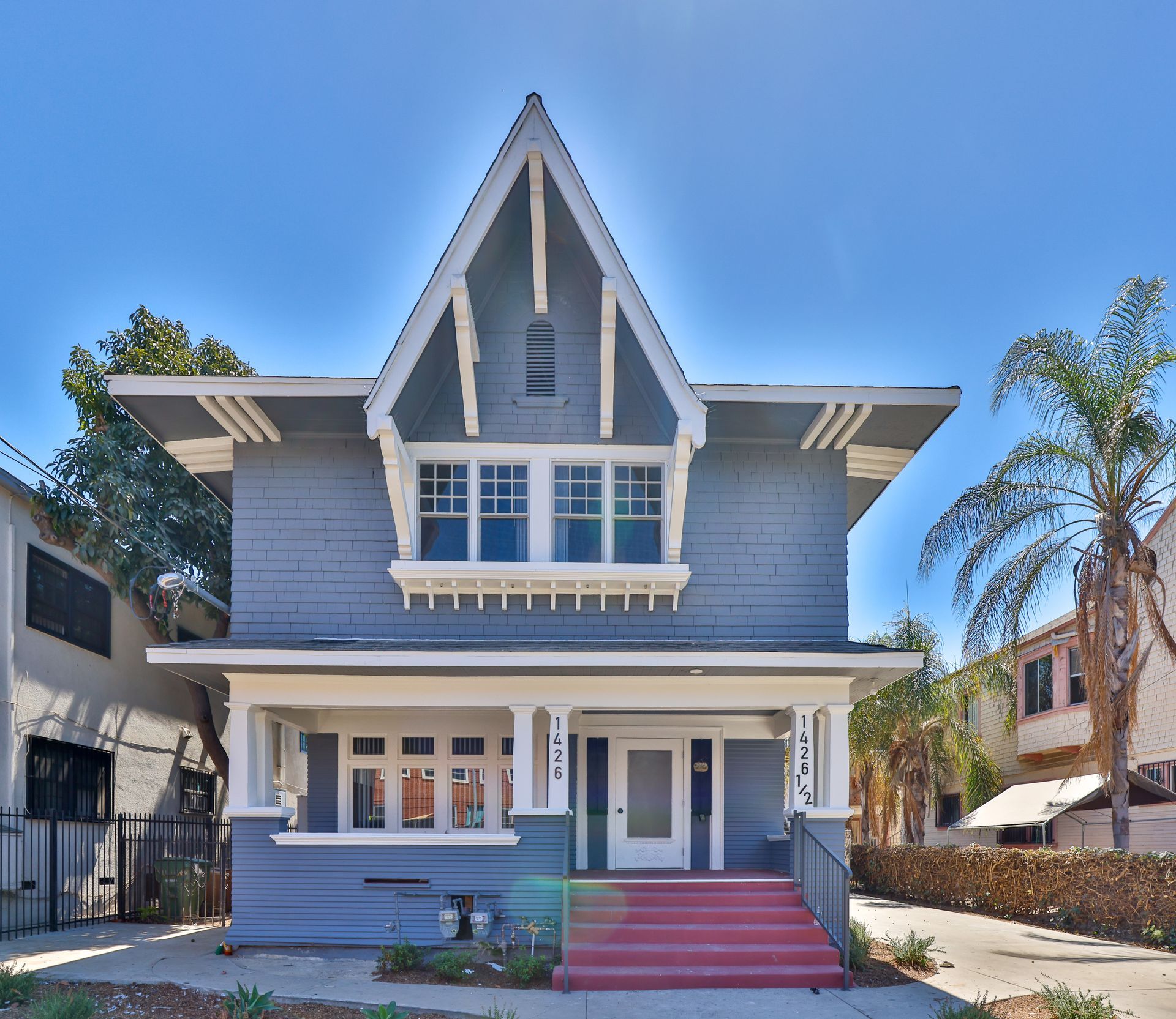 This image shows a house with white and grey color