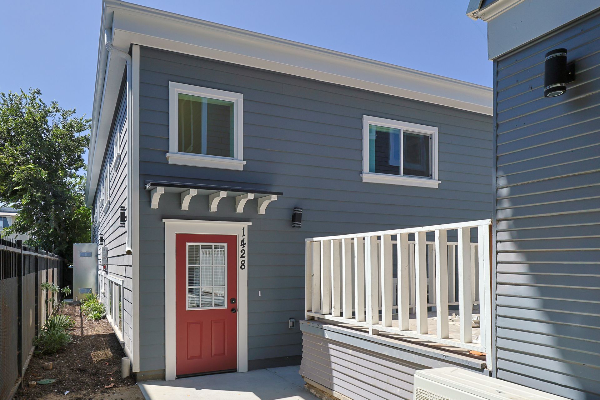 This image shows door and windows of the gray-colored house