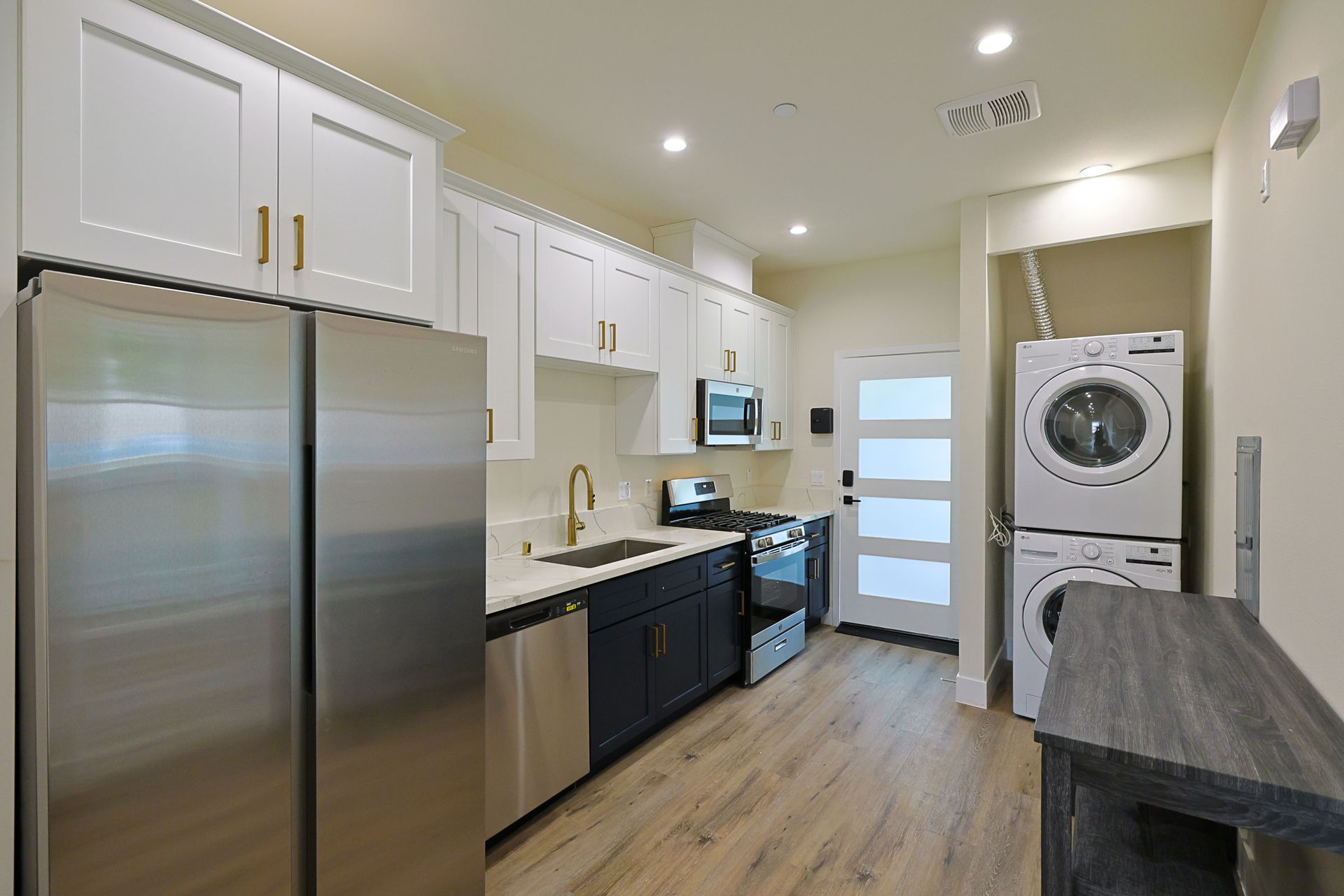 This image shows a kitchen with white cabinets and appliances