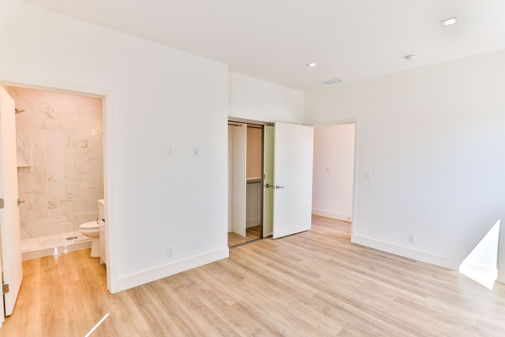 this image shows a room and attach bath with it .