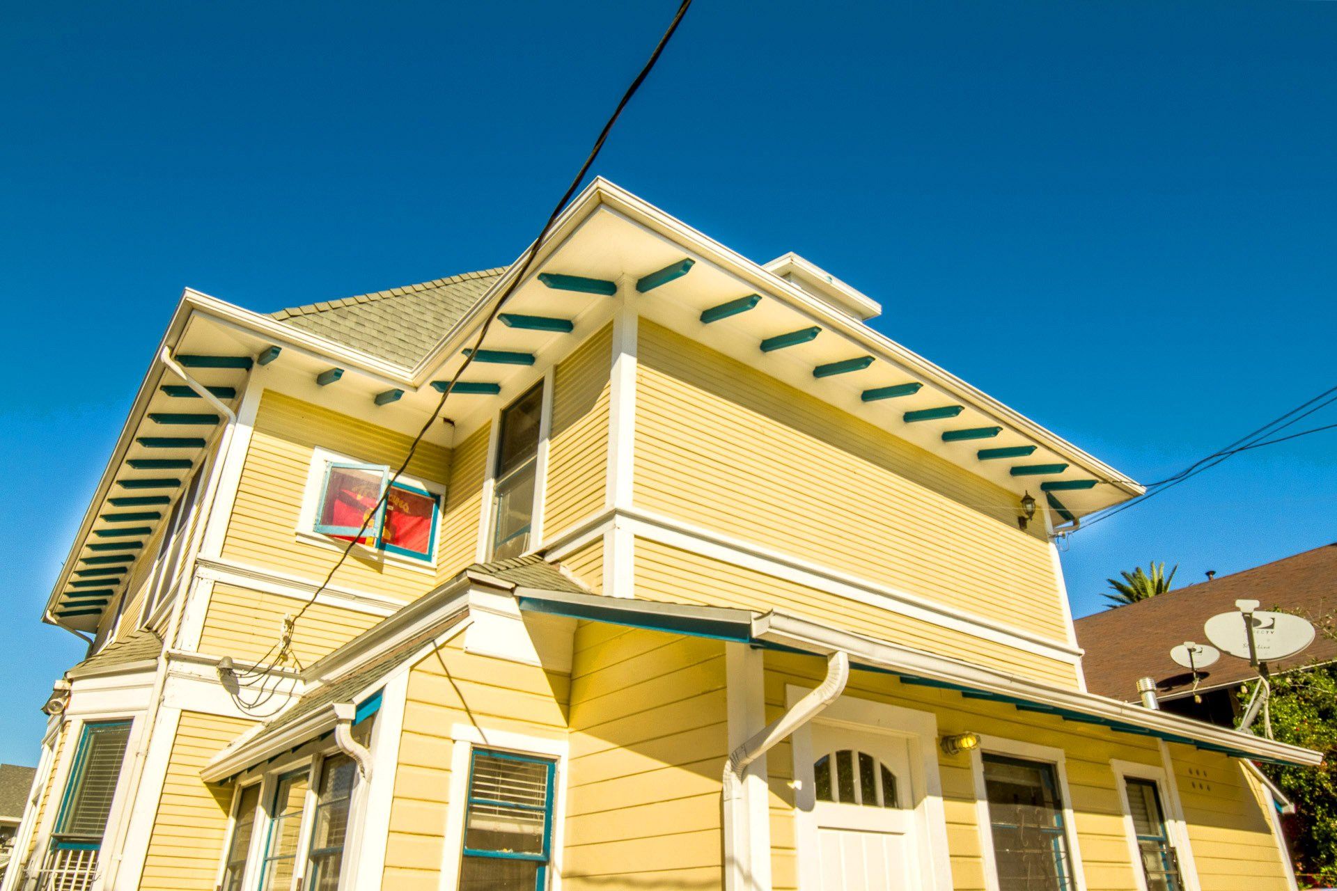 This image showing a large house in yellow colour
