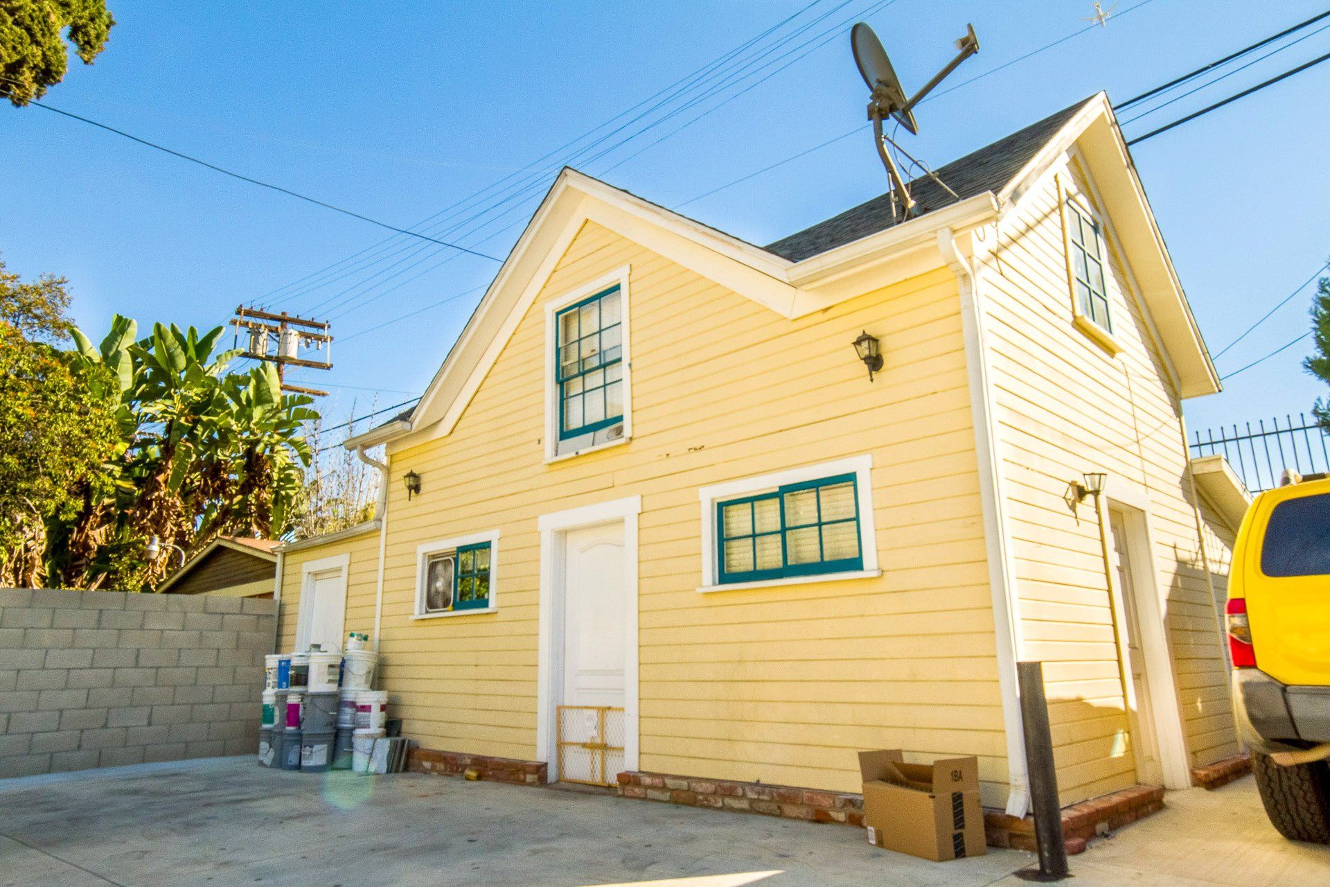 This image showing a left side of house in ligh yellow colour.