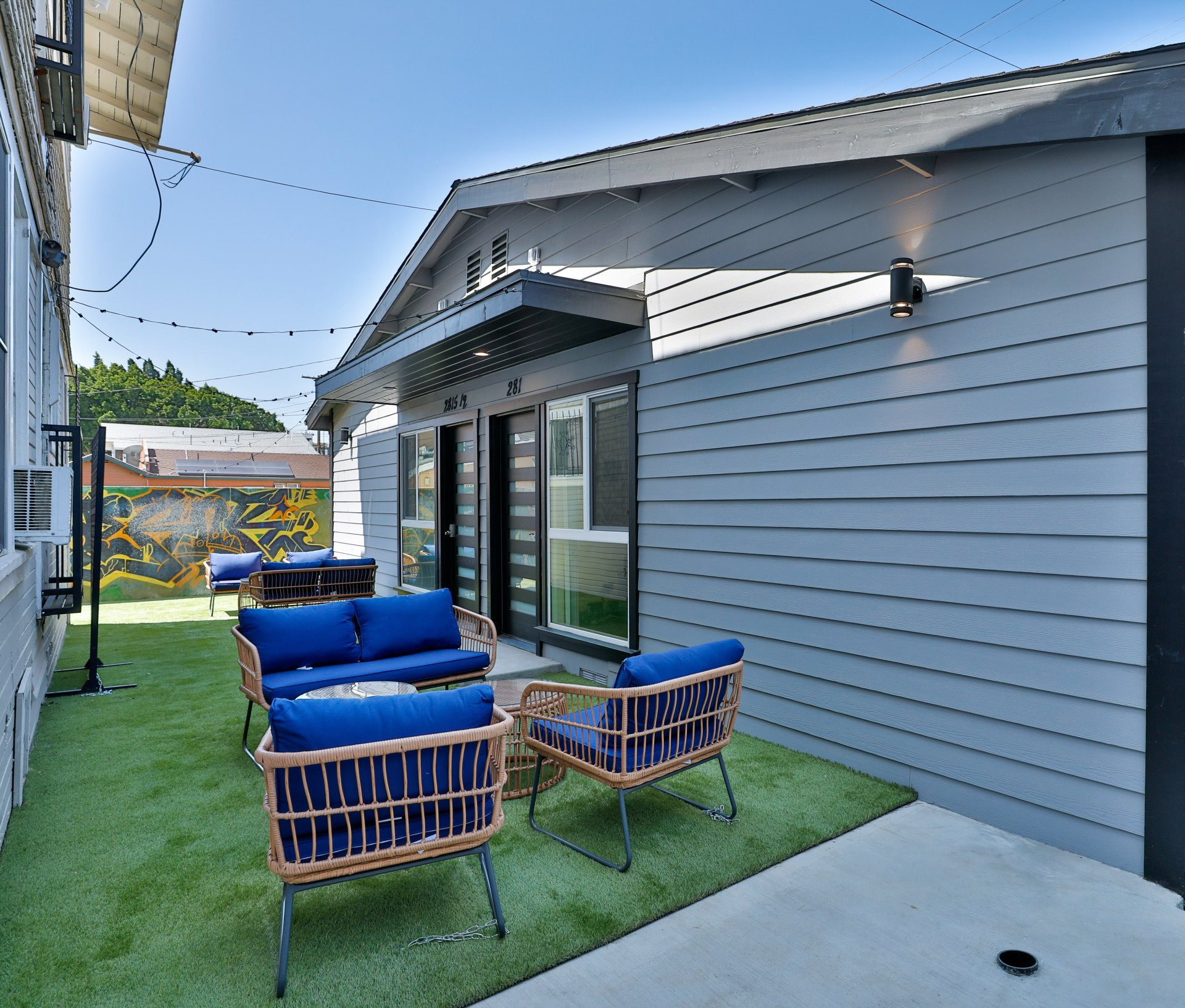 This image showing 8 chairs. 4 in front and 4 in back between two houses.