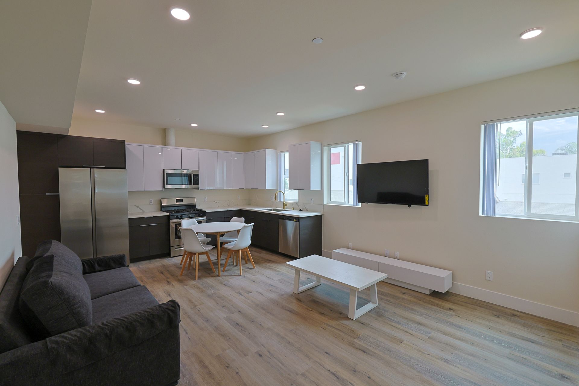 this image shows a sitting place with small open kitchen.