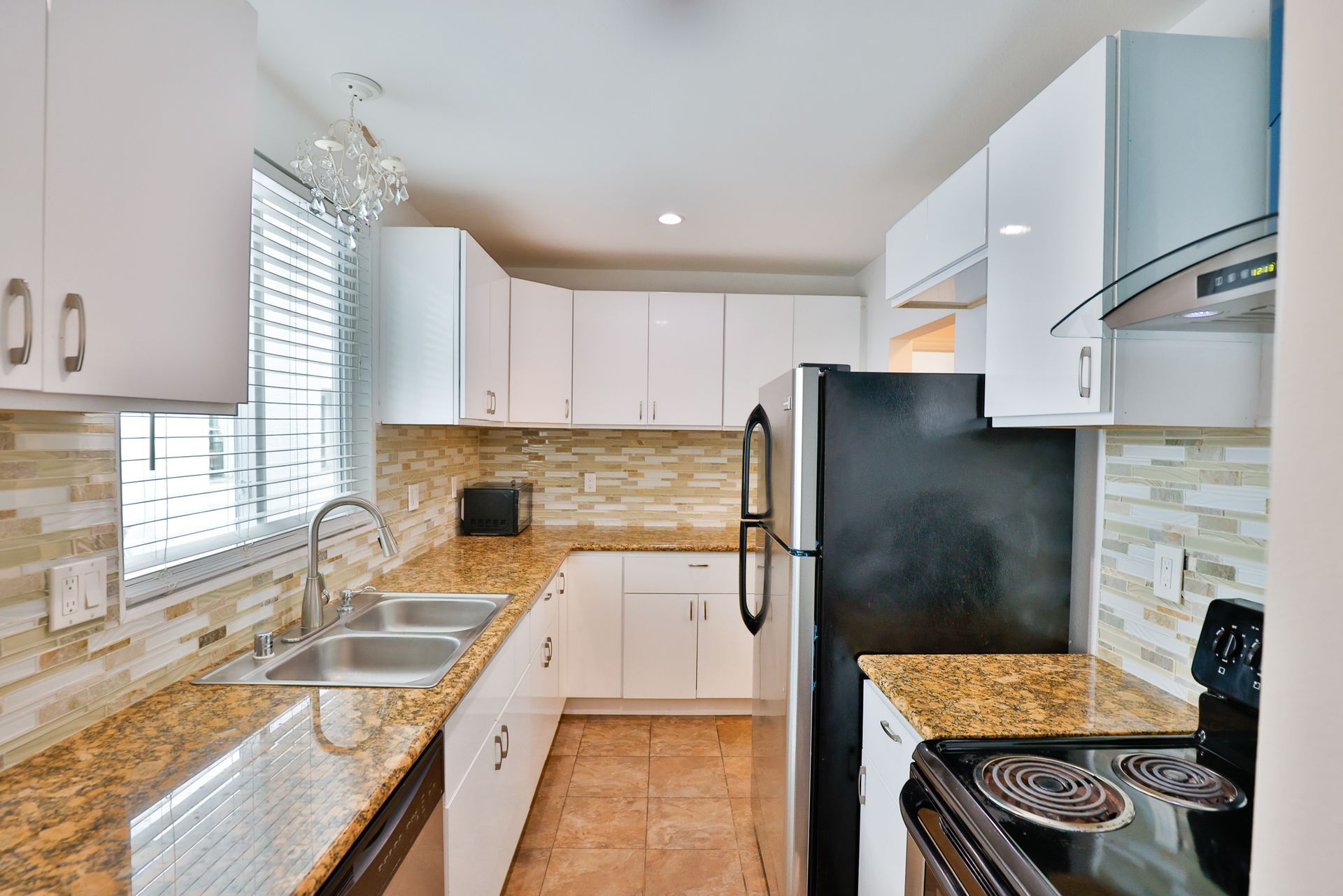 This image showing a luxurious kitchen with lots of luxurious accessories in it.