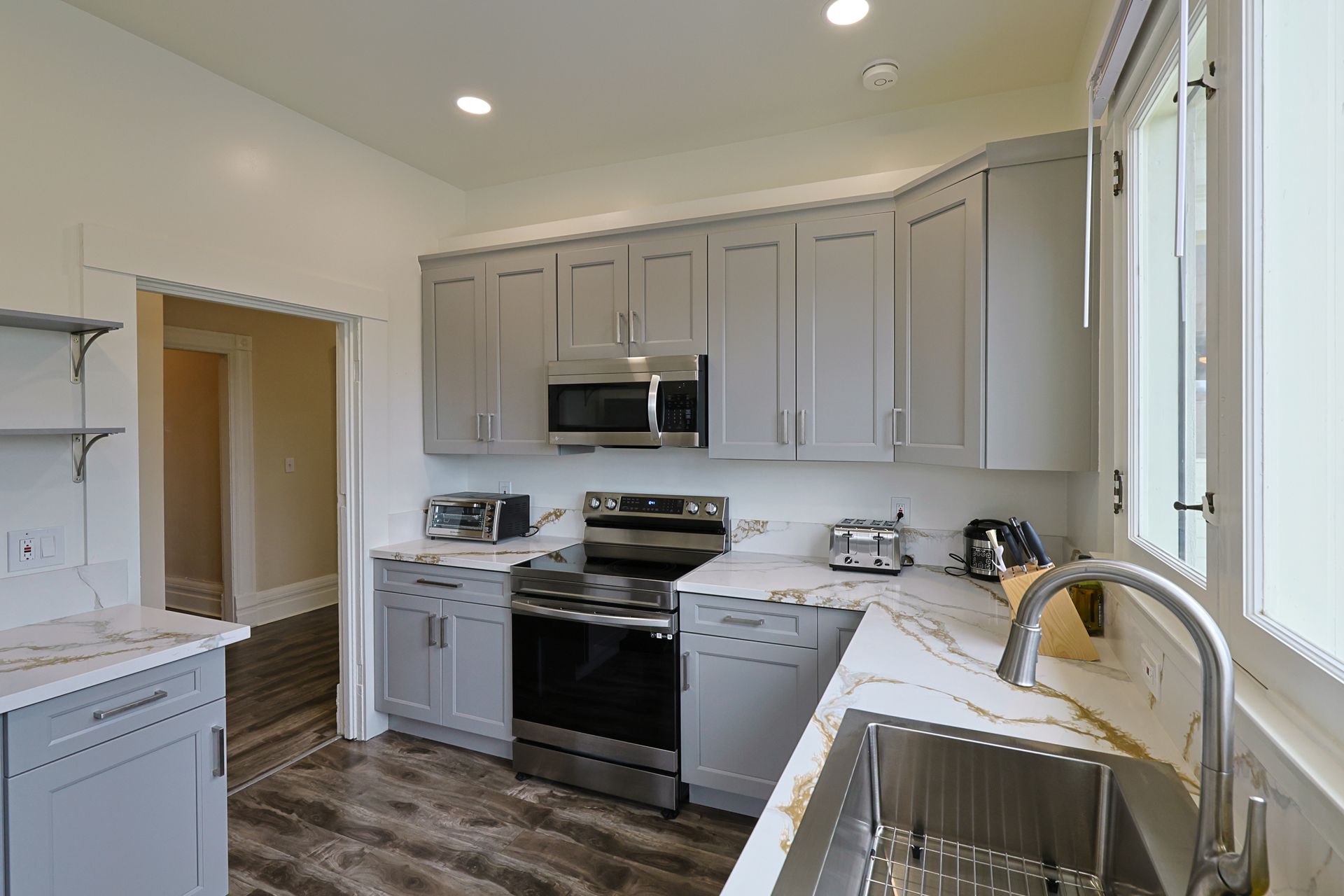 this image showing a beautifulkitchen with lots of accessories in white and black colour scheme.