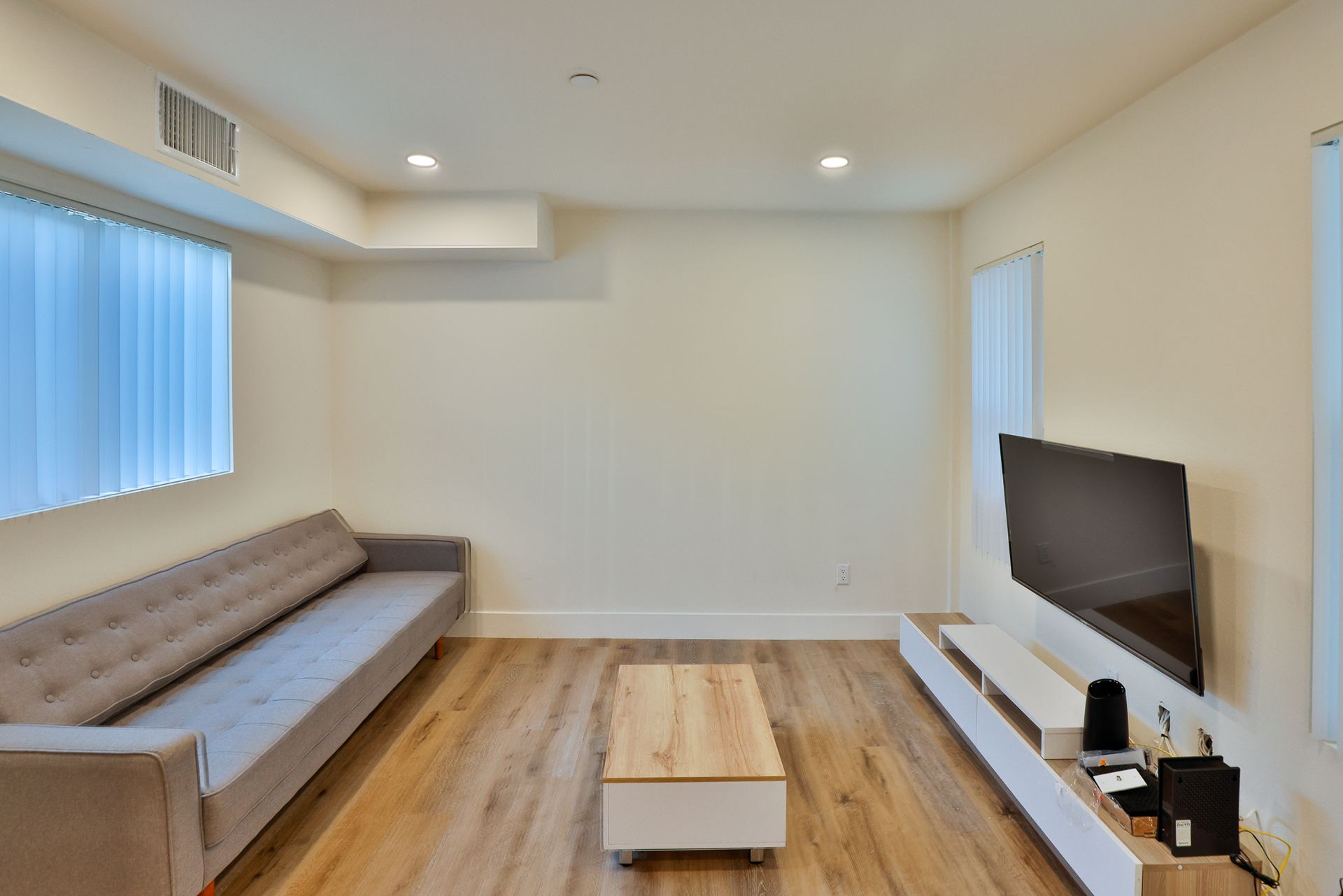 This image showing a living room with a large cough.