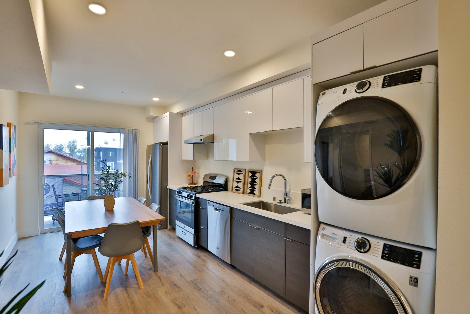 This image shows the kitchen with washing machines and a table.
