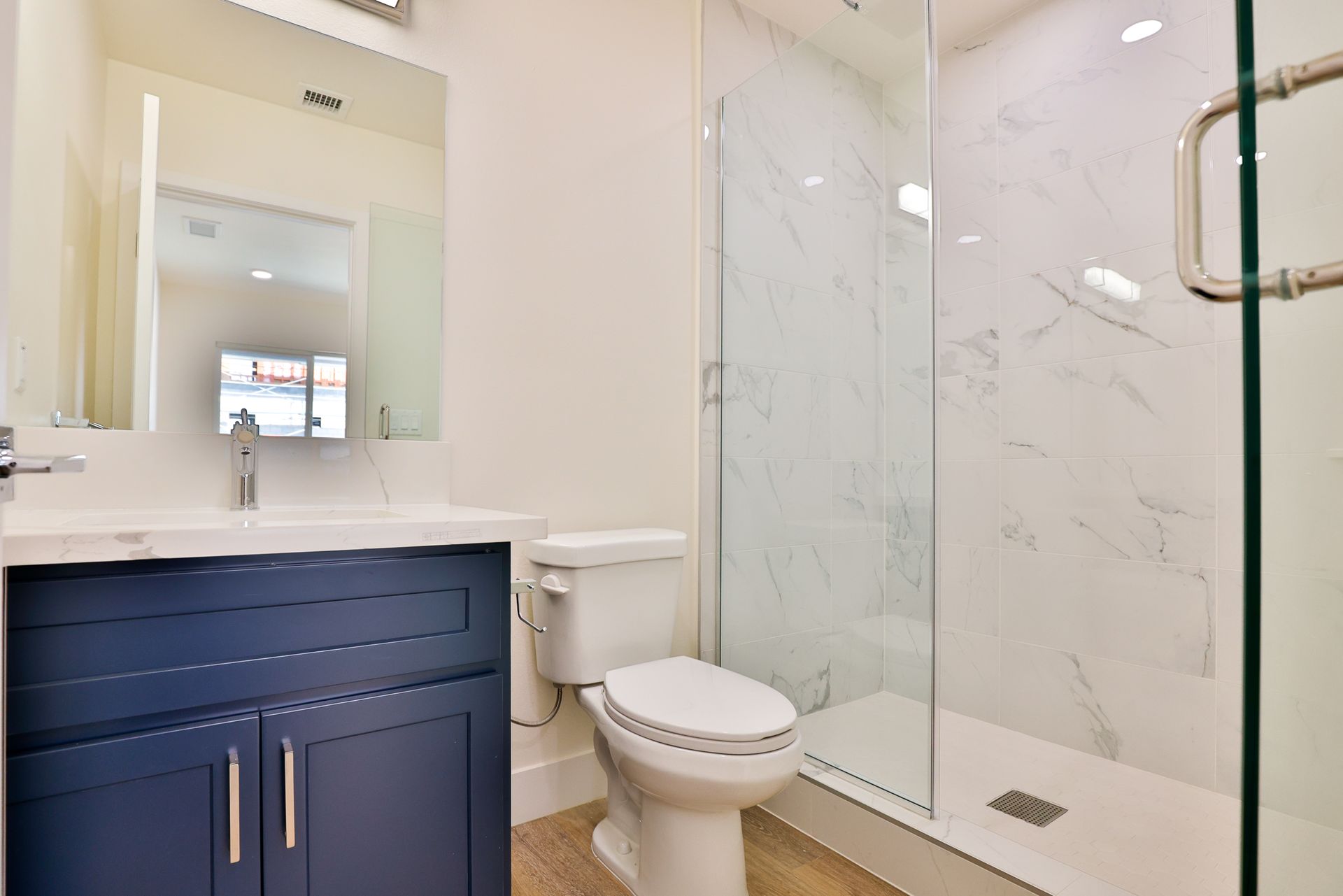 This image showing a elegant washroom in a white and royal blue colours