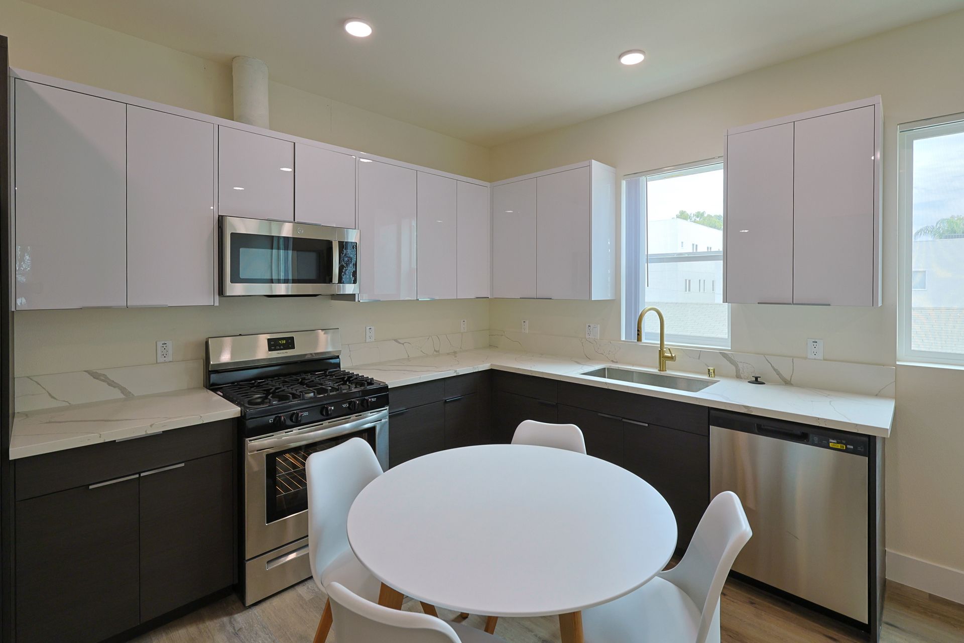 This image shows a small kitchen with one small dining table and four chairs.