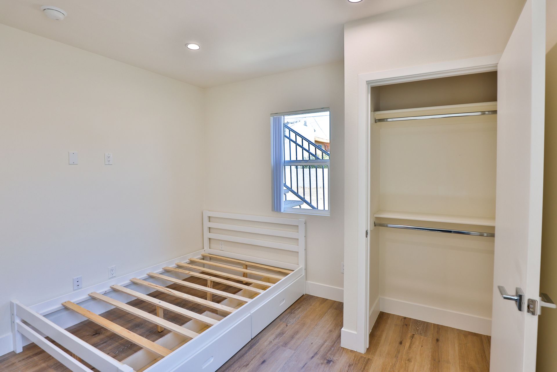 This image shows the wooden bed is in the room and the door is opened