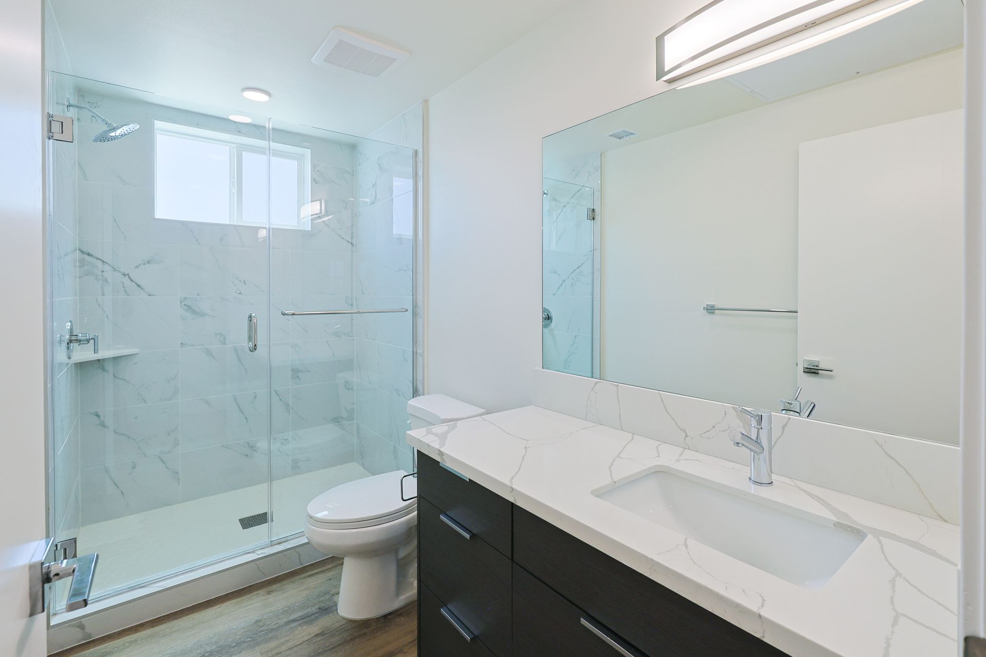 This image shows a small bathroom with white and black background.