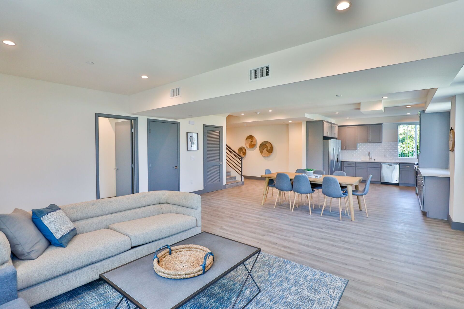 this image shows a living room with light blue and white theme
