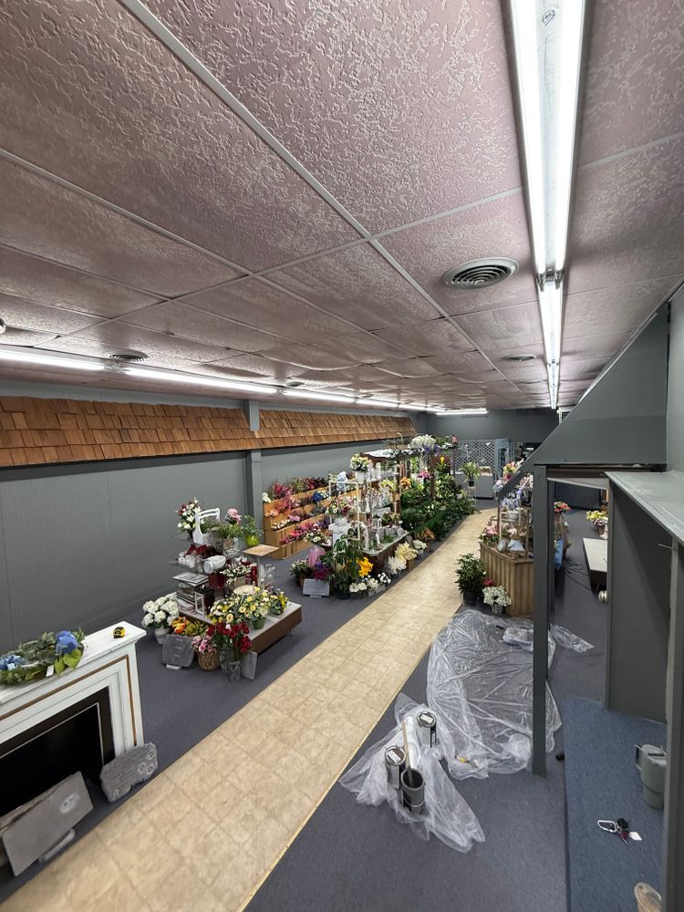 Flower shop aisle with rows of colorful bouquets and arrangements on display shelves