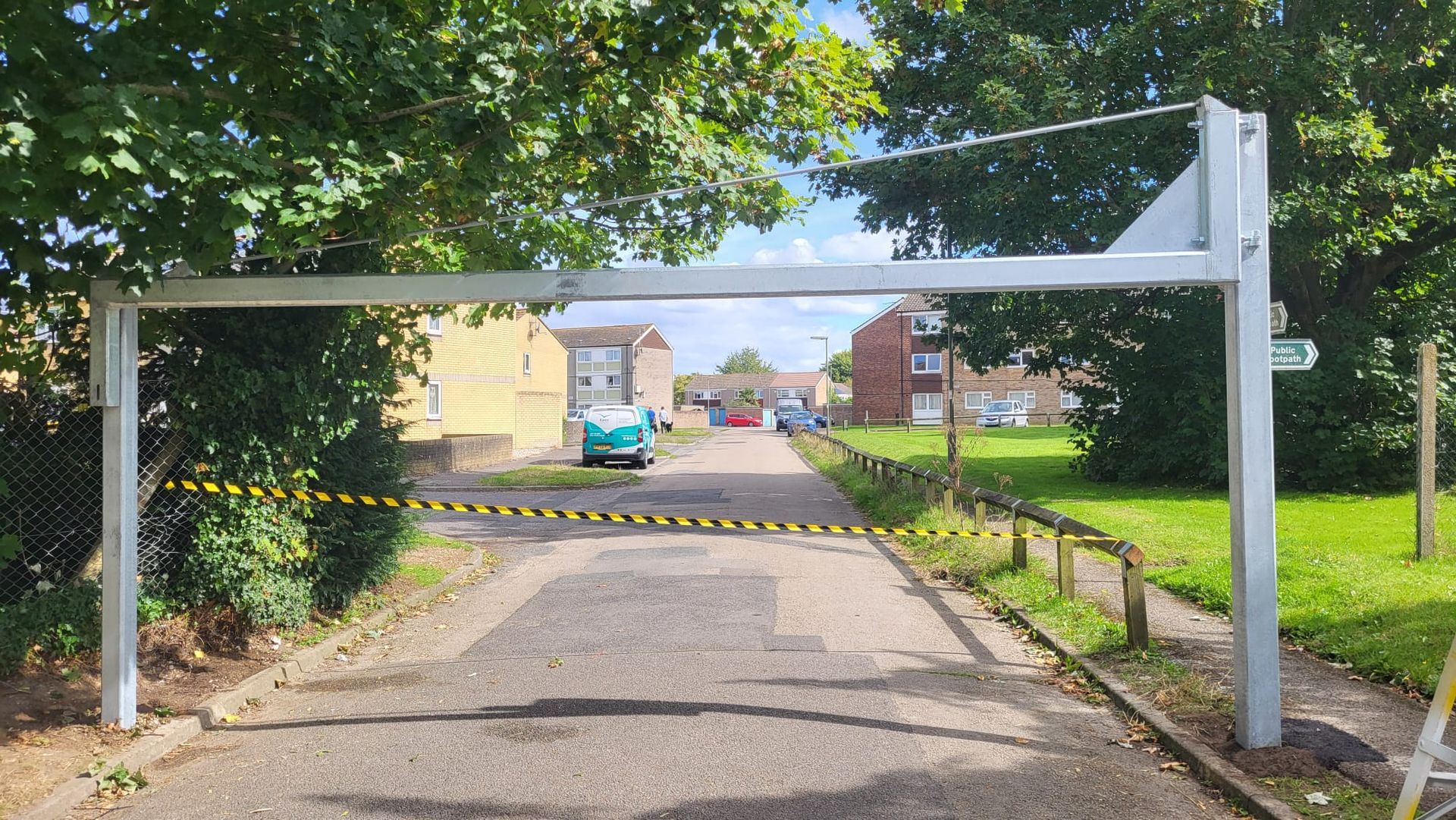 A white pole is sitting on the side of a road.