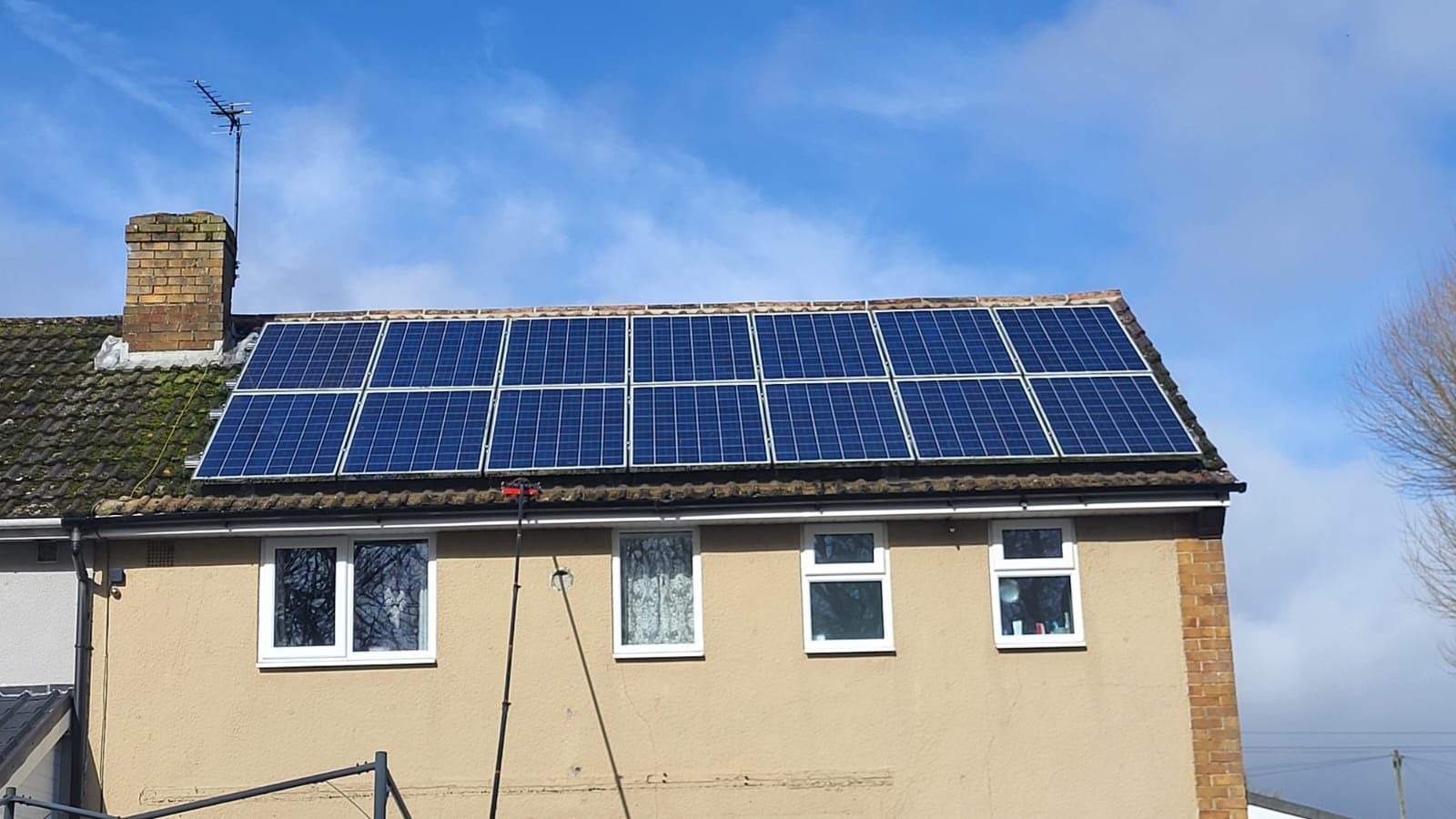 A house with a lot of clean solar panels on the roof
