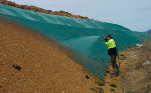 Man Spraying Seed — Canberra, ACT — ACT Spray Seeding