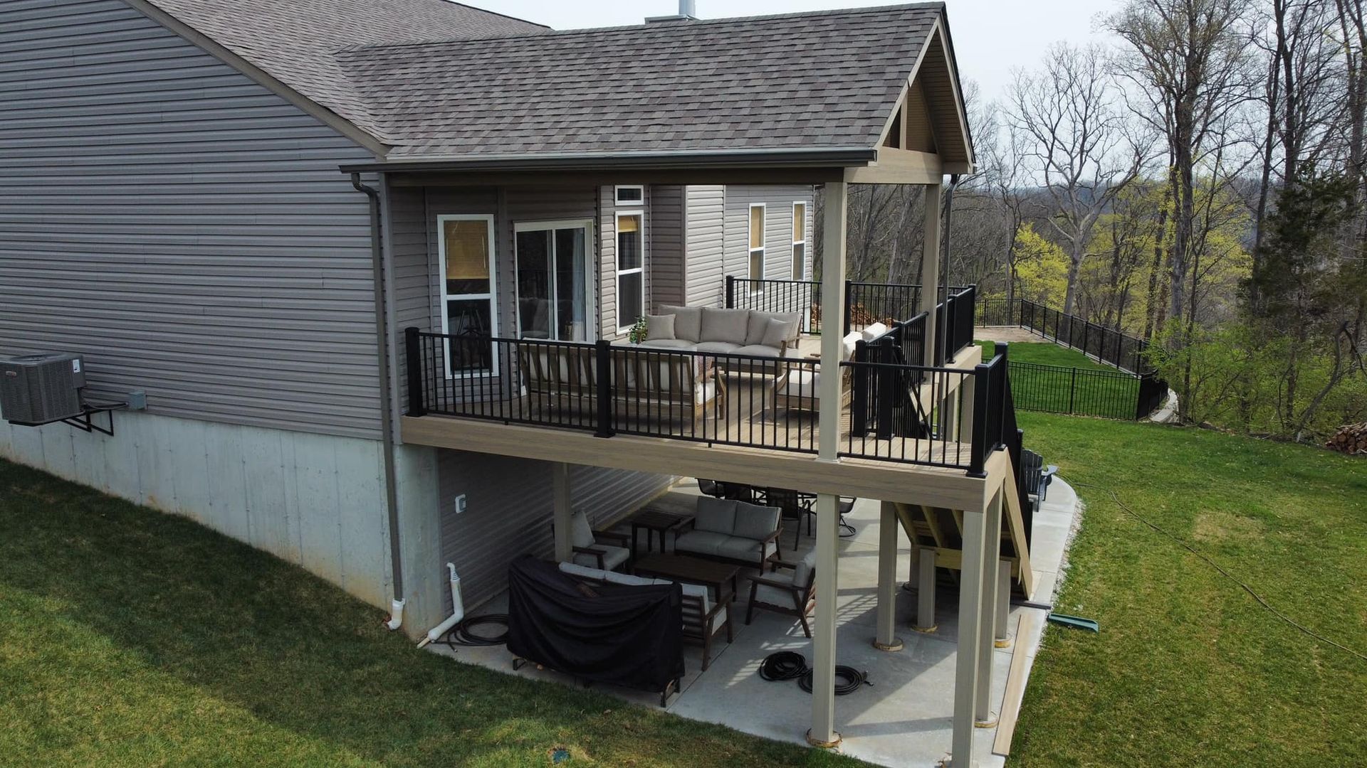 An aerial view of a house with a large deck.