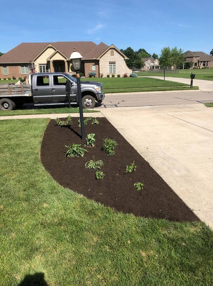 A truck is parked in the driveway of a house.