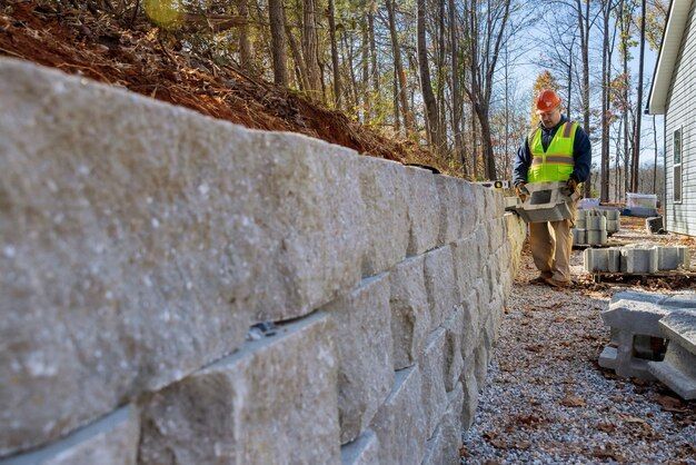 a man standing filing for a wall