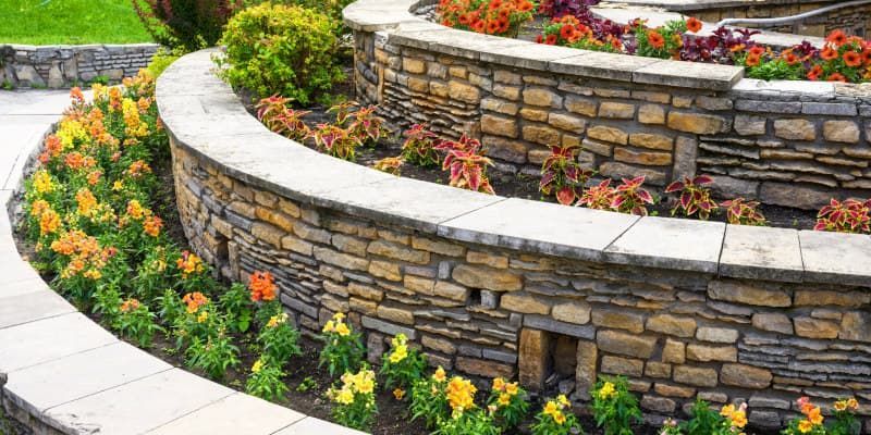 natural stone retaining wall build for garden area