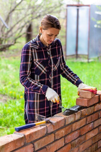 woman bricklaying cement