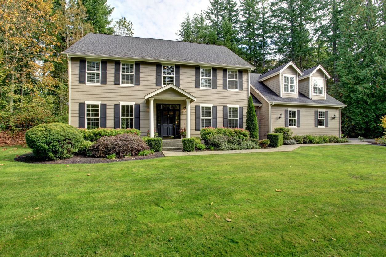 A large house with a large lawn in front of it
