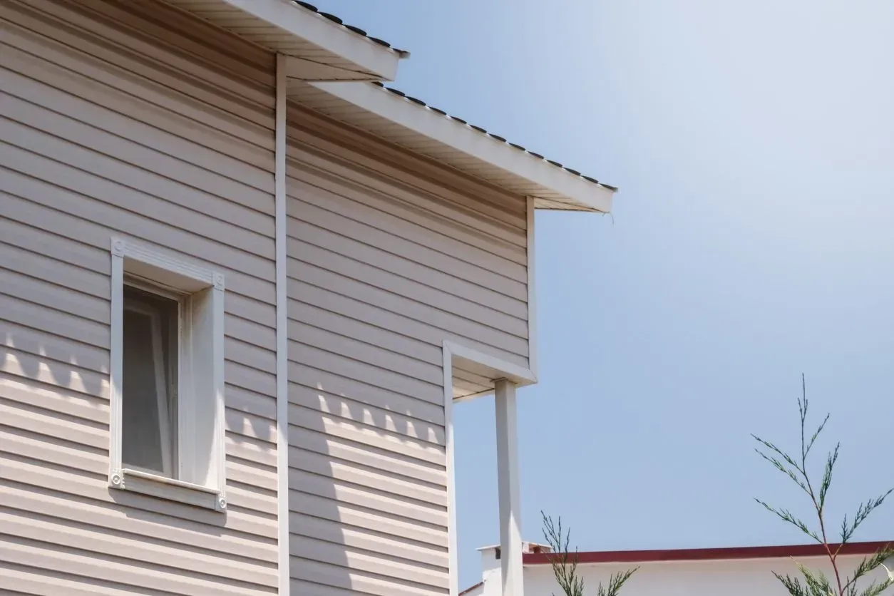 A white house with a window on the side of it