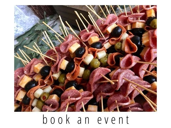 Skewers of assorted appetizers on a tray with “book an event” text below
