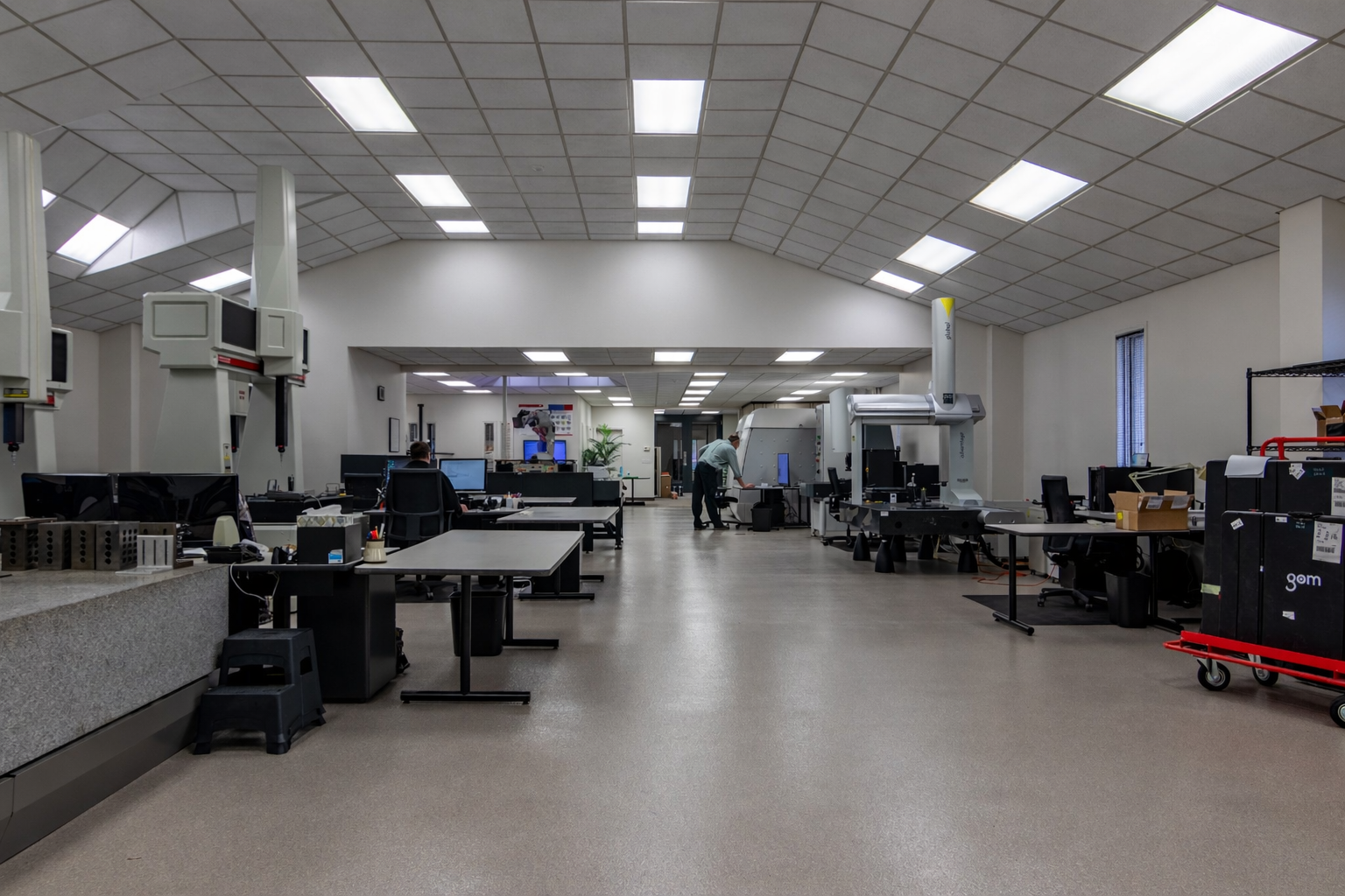 A bunch of metal cylinders are sitting on top of a wooden shelf.