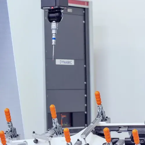 A machine with orange handles is sitting in front of a door that says dynamic.
