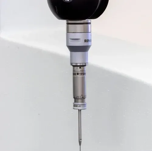 A close up of a machine with a needle sticking out of it.