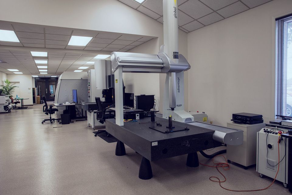 A large machine is sitting in the middle of a room.