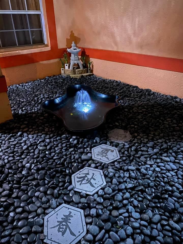 A large swimming pool is surrounded by a wooden fence.