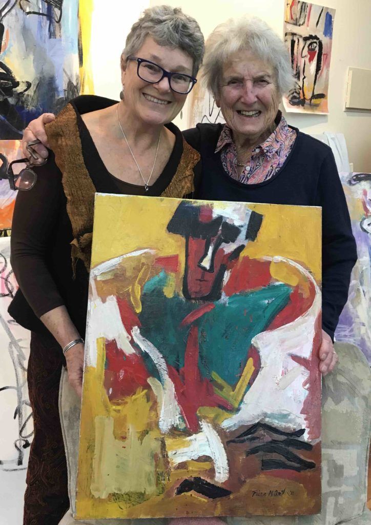 Anna Cahill and Piera McArthur in her studio with portrait of Douglas MacDiarmid