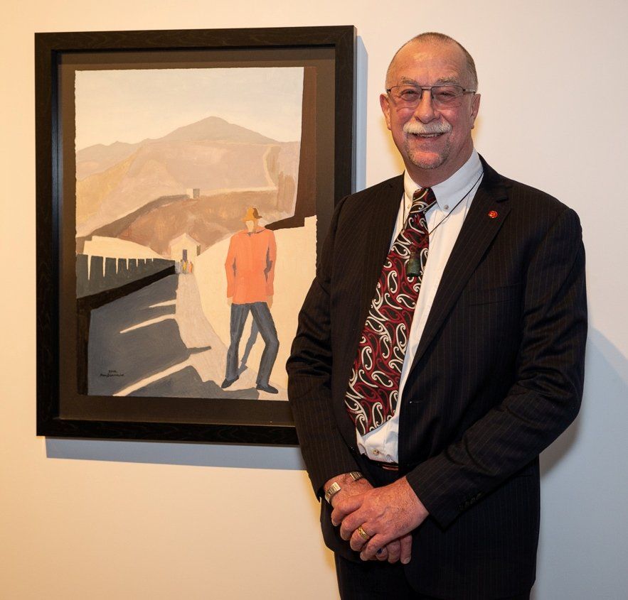 Stuart MacDiarmid poses with his portrait at the opening of the New Zealand Portrait Gallery exhibition on July 12, 2018. Image: James Gilberd, Photospace.