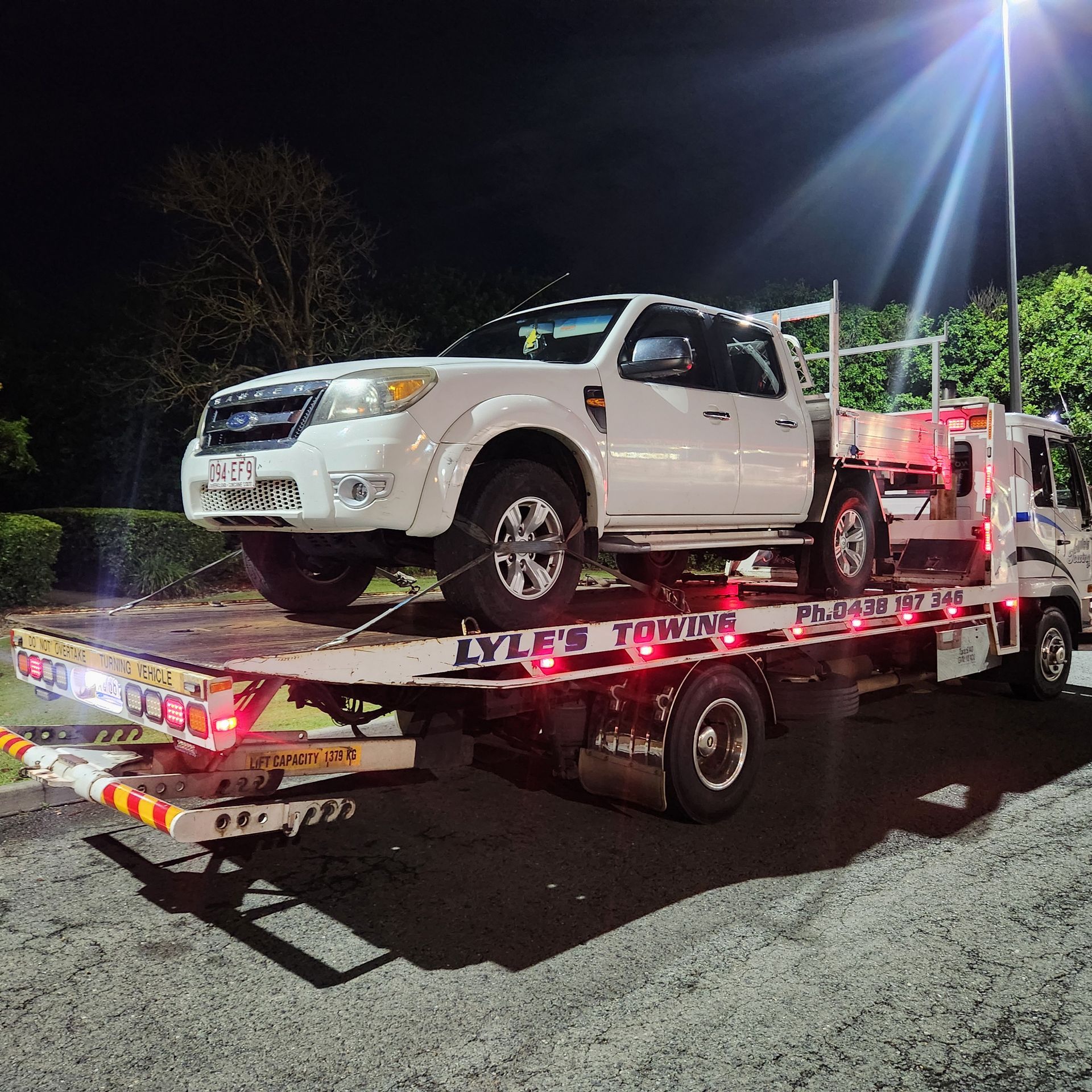 A White Truck is Sitting on Top of a Tow Truck — Lyle's Towing In Maroochydore, QLD