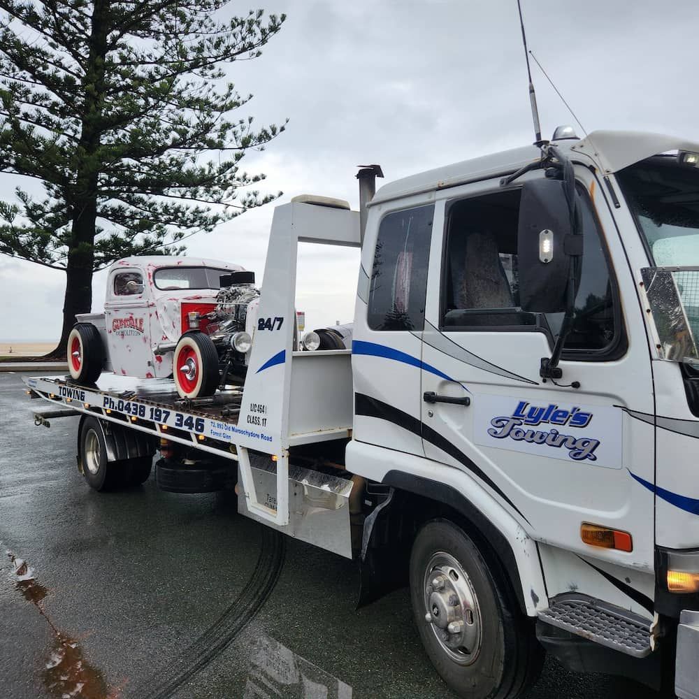 A Tow Truck With a Car on the Back of It — Lyle's Towing In Little Mountain, QLD