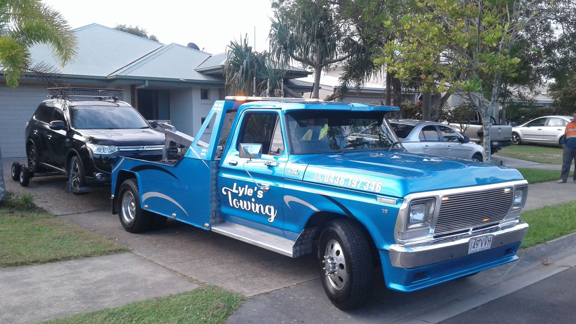 A Blue Tow Truck is Parked in Front of a House — Lyle's Towing In Landsborough, QLD