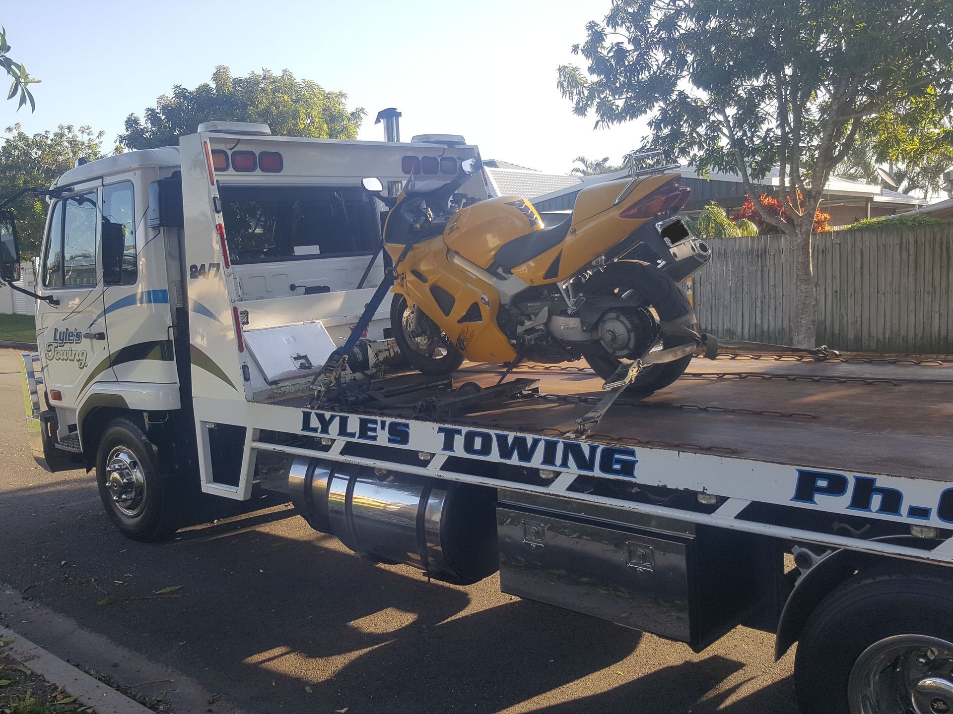 A Tow Truck towing a Yellow Motorcycle — Lyle's Towing In Little Mountain, QLD