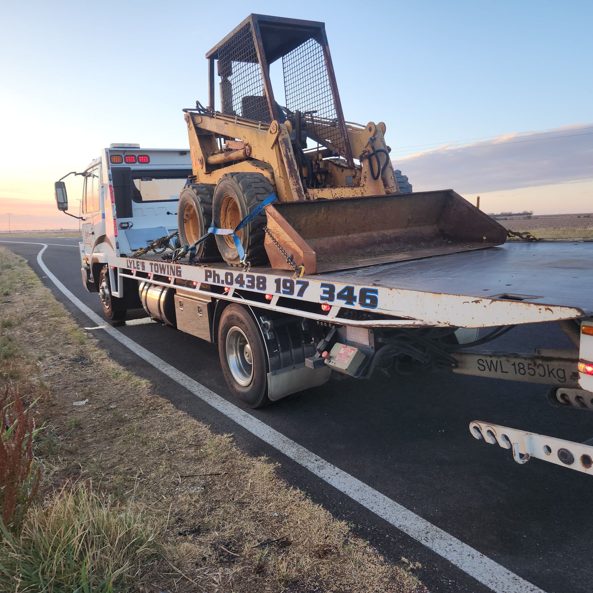 A Tow Truck towing a Excavator — Lyle's Towing In Little Mountain, QLD
