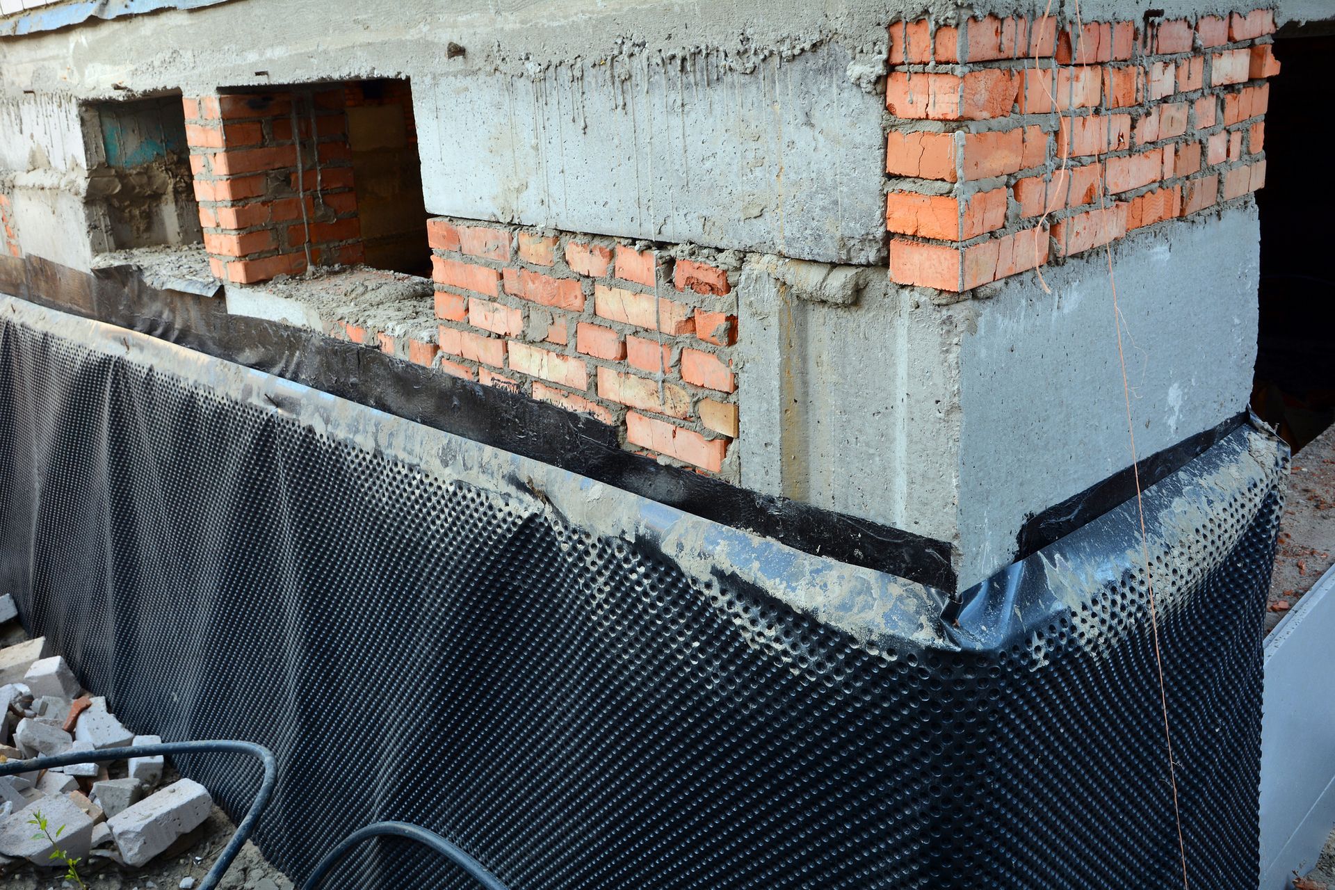 Tarp draped over a brick wall, showcasing Accurate Foundation Repair LLC's expertise in foundation r