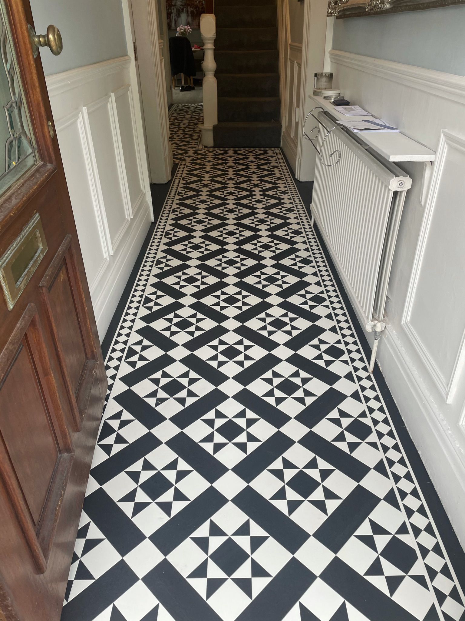 'a lovely installation of a  traditional style tile affect of LVT flooring