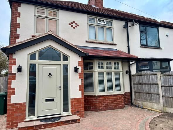 Modern property transformation in Middleton Manchester featuring a newly built porch, flush casement uPVC windows with mechanical joints, premium composite entrance door, reeded glass side panels, and specially sourced roof tiles installed by Peeco Ltd