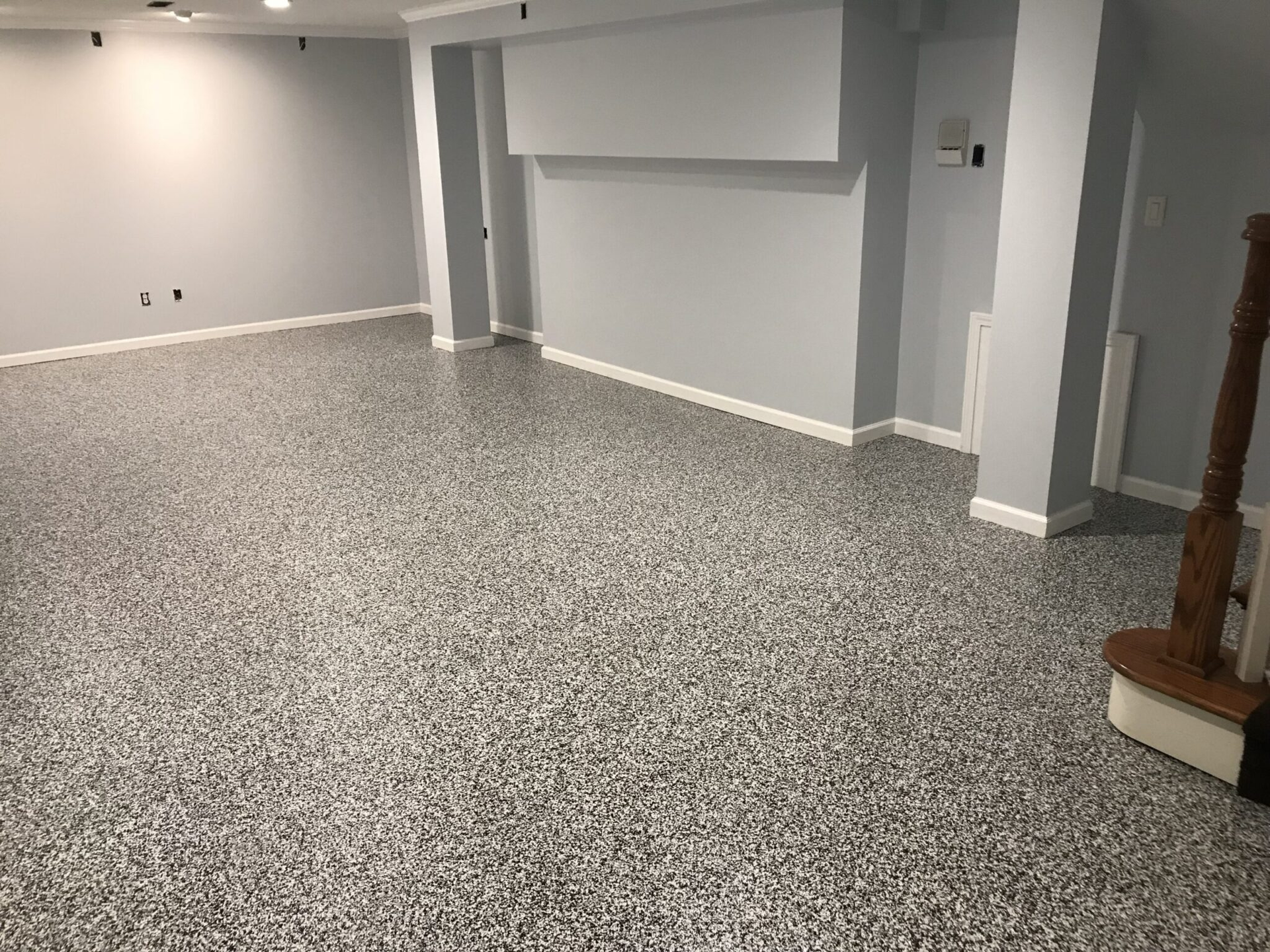 Gray speckled epoxy floor in a room with gray walls and white trim.