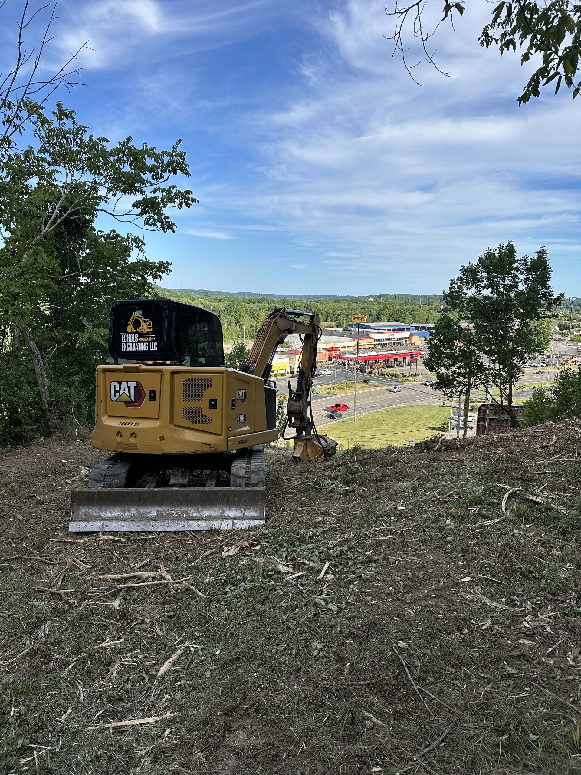 A bulldozer is sitting in the middle of a field.