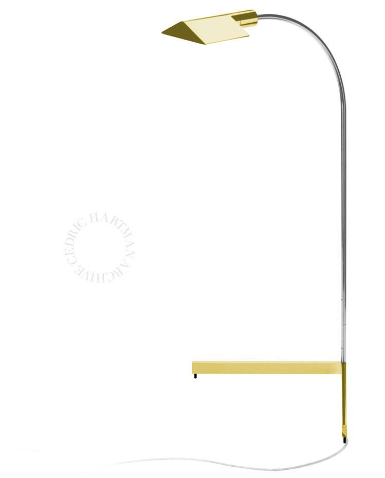 a brass lamp with a shelf attached to it on a white background .