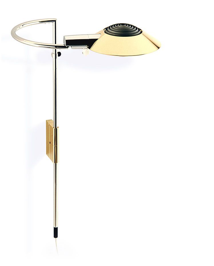 a wall light with a brass shade on a white background .