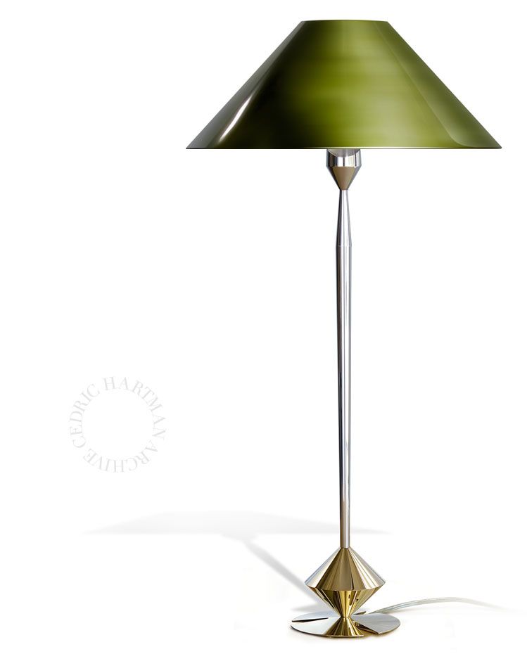 a table lamp with a green shade on a white background .