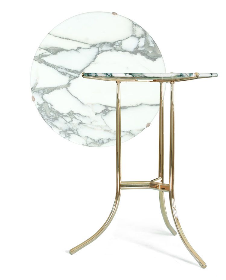 a round table with a marble top and gold legs